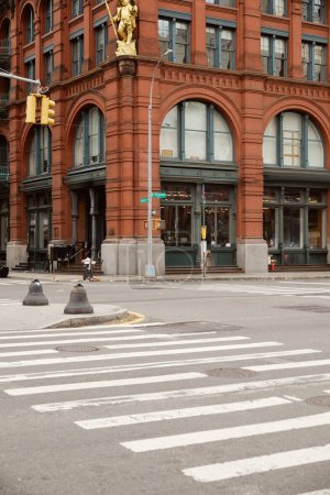 famous puck building near pedestrian crossing in manhattan district, landmark of new york city