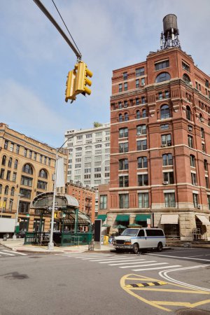 new york street with modern and vintage buildings near traffic intersection with traffic lights