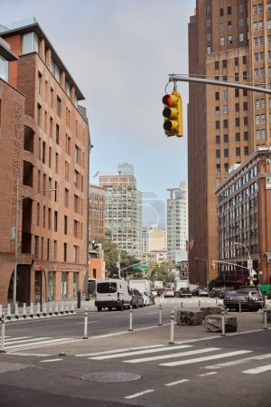 traffic lights over pedestrian crossing near roadway with moving vehicles, new york urban scene