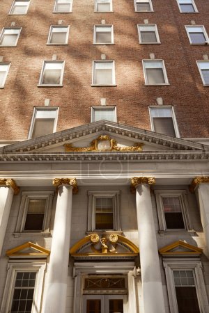 low angle view of brick building with columns and portico, vintage architecture of new york city