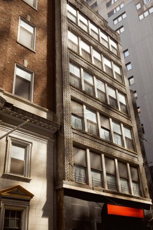 modern and vintage buildings on urban street in new york city, creative architectural symbiosis