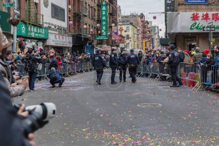 Photo for New York, Chinatown, USA - February 12, 2023: Policemen watching in Chinatown ahead of the New Year's Day Parade where the public gathers for the Year of the Rabbit (Mao) - Royalty Free Image
