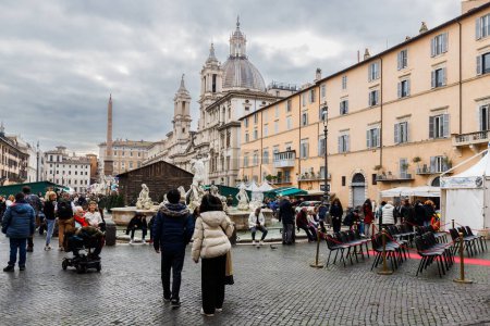 Photo for Rome, Italy - December 29, 2023: view of Navona Square and its fountains visited by tourists in the historic city center on a winter day - Royalty Free Image