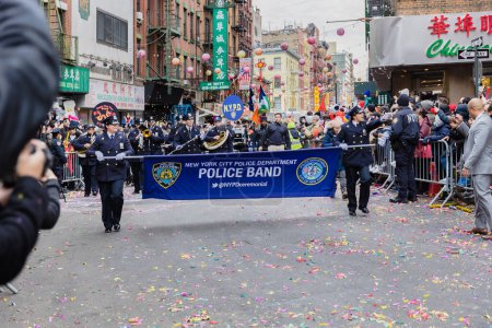 Photo for New York, Chinatown, USA - February 12, 2023: New York City Police Department Police Band marching past the public during the Chinatown Chinese New Year 2023 celebration - Royalty Free Image