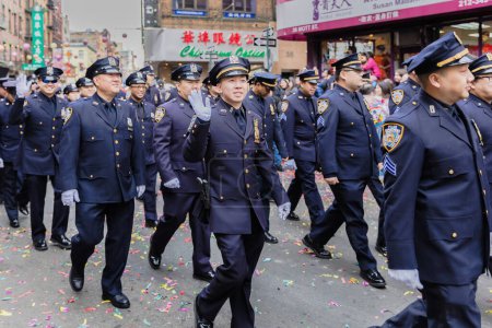 Photo for New York, Chinatown, USA - February 12, 2023: NYPD Asian Jade Society parading in front of the public during the Chinatown Chinese New Year 2023 celebration - Royalty Free Image