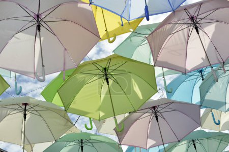 Photo for Mixed color of umbrella stacks with blue sky cloud background - Royalty Free Image