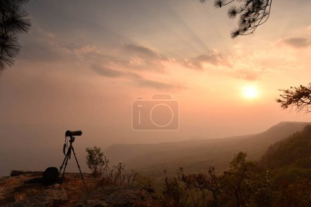 Photo for Camera and tripod silhouette on a cliff in sunrise time - Royalty Free Image