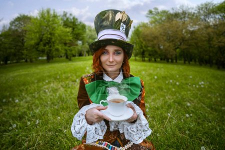 Photo for Beautiful woman as mad hatter with hats in nature - Royalty Free Image