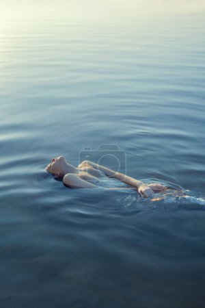 Photo for Beautiful redhead woman as mermaid in the lake - Royalty Free Image