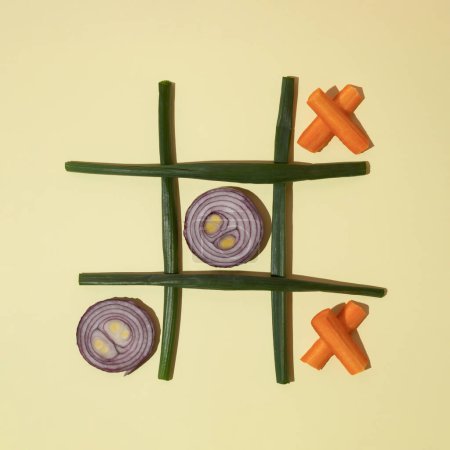 Tic tac toe from onion and carrot . Flat lay. Healthy food concept.