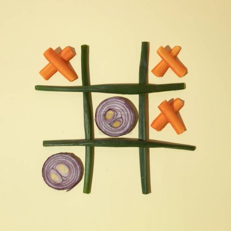 Onion and carrot tic tac toe. Flat lay. Healthy food concept.
