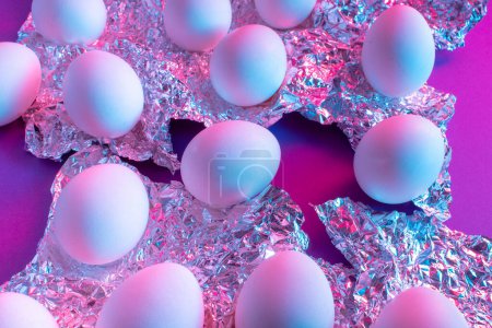 Photo for White Easter egg with colorful ultraviolet holographic neon lights. Creative concept. - Royalty Free Image