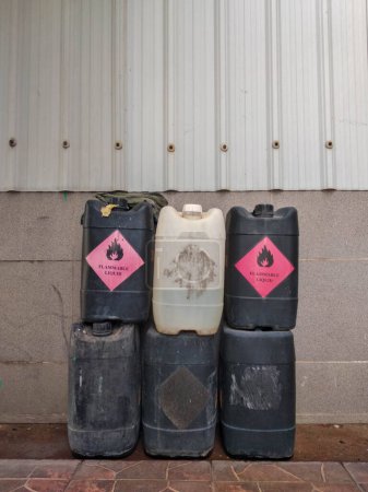Jerry cans or canisters of flammable chemicals are stacked in piles