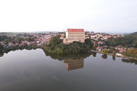 Photo for Aerial view of picturesque Czech town Plumlov with castle, Olomouc Region,reflected on the surface of Plumlov Lake, designed by Charles Eusebius of Liechtenstein. Tourist spot, Czech republic - Royalty Free Image