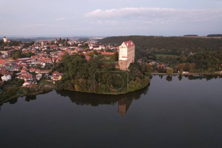 Photo for Aerial view of picturesque Czech town Plumlov with castle, Olomouc Region,reflected on the surface of Plumlov Lake, designed by Charles Eusebius of Liechtenstein. Tourist spot, Czech republic - Royalty Free Image