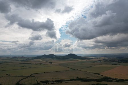 Photo for Ceske Stredohori hill range and protected landscape,aerial scenic panorama mountains view,Rana hill,Czech republic by Louny Town,Europeclear summer sky with clouds - Royalty Free Image