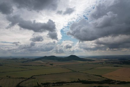 Photo for Ceske Stredohori hill range and protected landscape,aerial scenic panorama mountains view,Rana hill,Czech republic by Louny Town,Europeclear summer sky with clouds - Royalty Free Image