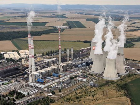 Photo for Pocerady, Czech republic - June 28 2023: Aerial panorama view of Pocerady coal power plant with smokestacks and cooling towers in the middle of nothern Bohemian landscape.Huge energy sources - Royalty Free Image