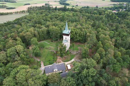 Photo for Aerial view of The Bolfanek viewtower with the St. Wolfgangs cemetery chapel. Near a marvelous village Chudenice from 12th century.Czech landmarks from above. Golden autumn in Central Europe,lookout - Royalty Free Image