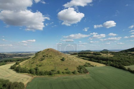 Ceske Stredohori hill range and protected landscape,aerial scenic panorama mountains view,Rana hill,Czech republic by Louny Town,Europe clear summer sky with clouds