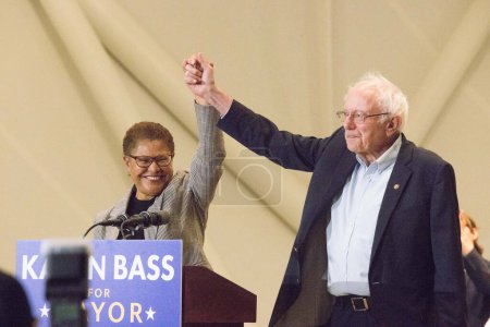 Photo for United States Representative Karen Bass (D-CA) and American politician/United States Senator Bernie Sanders (I-VT) join hands onstage at the Los Angeles Mayoral Candidate Karen Bass GOTV Rally Featuring US Senator Bernie Sanders  on October 27, 2022 - Royalty Free Image