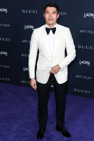 Photo for Henry Golding arrives at the 11th Annual LACMA Art + Film Gala 2022 presented by Gucci held at the Los Angeles County Museum of Art on November 5, 2022 in Los Angeles, California, United States. - Royalty Free Image