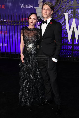 Photo for American actress Christina Ricci wearing Rodarte and husband/hair stylist Mark Hampton arrive at the World Premiere Of Netflix's 'Wednesday' Season 1 held at the Hollywood American Legion Post 43 at Hollywood Legion Theater on November 16, 2022 - Royalty Free Image