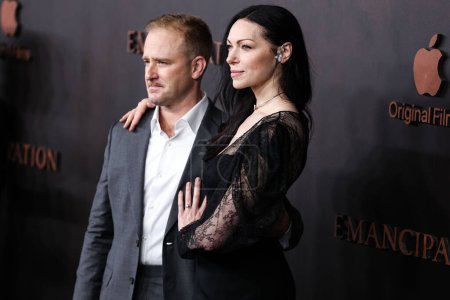 Photo for Ben Foster  and wife/American actress Laura Prepon wearing a Pamella Rolland jumpsuit, Stuart Weitzman shoes  arrive at the Los Angeles Premiere Of Apple Original Films' 'Emancipation' on November 30, 2022 - Royalty Free Image