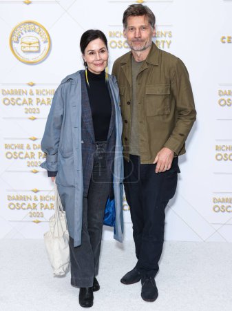 Photo for Miss Greenland Nukaka Coster-Waldau and husband/Danish actor Nikolaj Coster-Waldau arrive at the Darren Dzienciol and Richie Akiva Oscar Party 2023 held at a Private Residence on March 10, 2023  in Bel Air, Los Angeles, California, United States. - Royalty Free Image