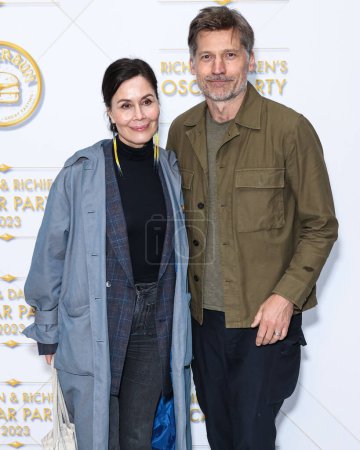 Photo for Miss Greenland Nukaka Coster-Waldau and husband/Danish actor Nikolaj Coster-Waldau arrive at the Darren Dzienciol and Richie Akiva Oscar Party 2023 held at a Private Residence on March 10, 2023  in Bel Air, Los Angeles, California, United States. - Royalty Free Image
