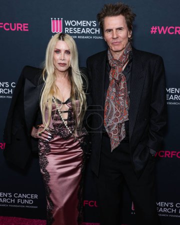 Photo for Gela Nash-Taylor and husband/British musician John Taylor of English rock band Duran Duran arrive at The Women's Cancer Research Fund's An Unforgettable Evening Benefit Gala 2023 held at the Beverly Wilshire, A Four Seasons Hotel on March 16, 2023 - Royalty Free Image