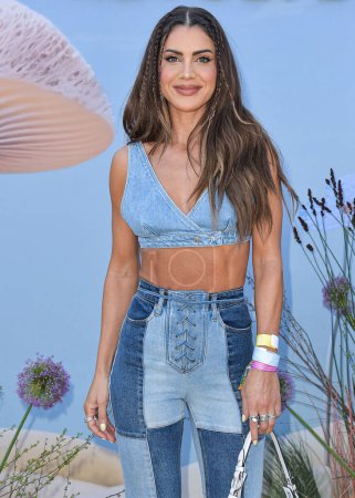 Photo for Camila Coelho arrives at the REVOLVE Festival 2023 celebrating the 20th Anniversary of REVOLVE in partnership with The h.wood Group on April 15, 2023 in Thermal, Coachella Valley, Riverside County, California, United States. - Royalty Free Image