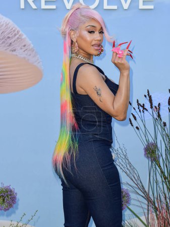 Photo for Saweetie arrives at the REVOLVE Festival 2023 celebrating the 20th Anniversary of REVOLVE in partnership with The h.wood Group on April 15, 2023 in Thermal, Coachella Valley, Riverside County, California, United States. - Royalty Free Image