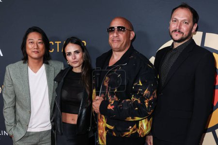Photo for Sung Kang, Jordana Brewster, Vin Diesel and Louis Leterrier arrive at the Charlize Theron Africa Outreach Project (CTAOP) 2023 Block Party held at the Universal Studios Backlot on May 20, 2023 in Universal City, Los Angeles, California, United States - Royalty Free Image