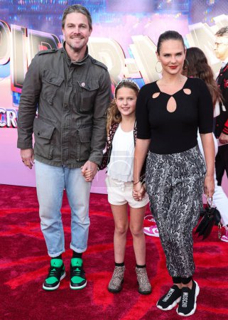 Photo for Stephen Amell, Maverick Alexandra Jean Amell and Cassandra Jean arrive at the World Premiere Of Sony Pictures Animation's 'Spider-Man: Across The Spider Verse' held at the Regency Village Theater on May 30, 2023 in Westwood, Los Angeles, California - Royalty Free Image