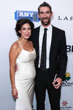 Photo for Nicole Johnson and husband/American former competitive swimmer Michael Phelps arrive at the 23rd Annual Harold And Carole Pump Foundation Gala held at The Beverly Hilton Hotel on August 18, 2023 in Beverly Hills, Los Angeles, California, USA - Royalty Free Image