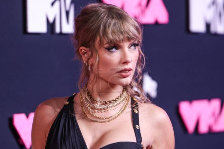Photo for American singer-songwriter Taylor Swift wearing a Versace dress arrives at the 2023 MTV Video Music Awards held at the Prudential Center on September 12, 2023 in Newark, New Jersey, United States. - Royalty Free Image