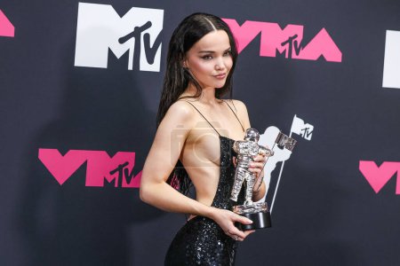 Photo for Dove Cameron wearing a Coach dress poses with the 'Video for Good' award for 'Breakfast' in the press room at the 2023 MTV Video Music Awards held at the Prudential Center on September 12, 2023 in Newark, New Jersey, United States. - Royalty Free Image