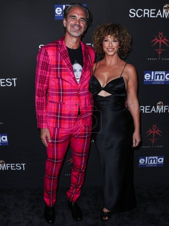 Photo for Canadian actor Steven Ogg and girlfriend Sarah Clark arrive at 23rd Annual Screamfest Horror Film Festival - Opening Night - Los Angeles Premiere Of Sumerian Films 'Divinity' held at the TCL Chinese Theatre IMAX on October 10, 2023 in Hollywood, LA - Royalty Free Image