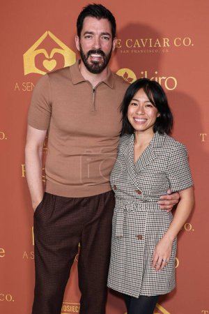 Photo for Canadian reality television personality Drew Scott and wife Linda Phan arrive at the annual, A Sense of Home Gala 2023, to help prevent homelessness by creating first ever homes and a community for youth aging out of foster care - Royalty Free Image