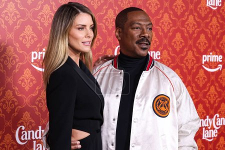 Photo for Australian actress Paige Butcher and fiance/American actor and comedian Eddie Murphy arrive at the World Premiere Of Amazon Prime Video's 'Candy Cane Lane' held at the Regency Village Theatre on November 28, 2023 in Westwood, Los Angeles, California - Royalty Free Image
