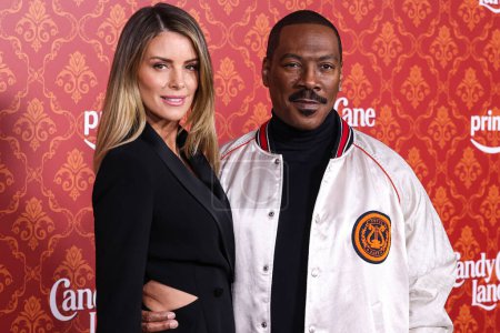 Photo for Australian actress Paige Butcher and fiance/American actor and comedian Eddie Murphy arrive at the World Premiere Of Amazon Prime Video's 'Candy Cane Lane' held at the Regency Village Theatre on November 28, 2023 in Westwood, Los Angeles, California - Royalty Free Image