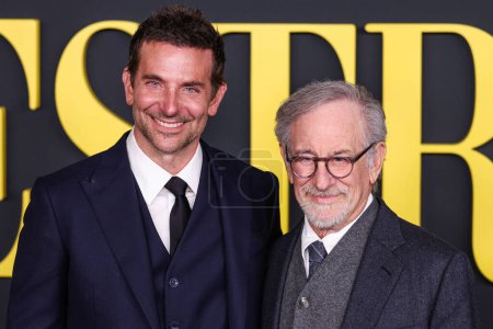 Photo for American actor and filmmaker Bradley Cooper wearing a Louis Vuitton suit and American film director, producer and screenwriter Steven Spielberg arrive at the Los Angeles Special Screening Of Netflix's 'Maestro' - Royalty Free Image