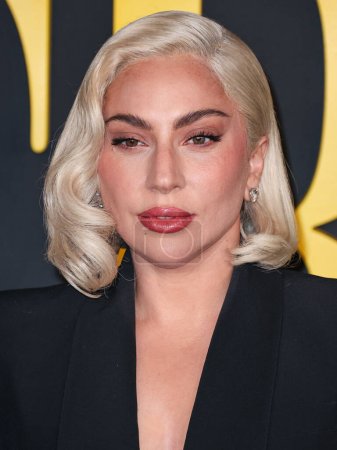 Photo for Lady Gaga (Stefani Joanne Angelina Germanotta) wearing an Alexander McQueen suit arrives at the Los Angeles Special Screening Of Netflix's 'Maestro' held at the Academy Museum of Motion Pictures on December 12, 2023 in Los Angeles - Royalty Free Image