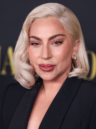 Photo for Lady Gaga (Stefani Joanne Angelina Germanotta) wearing an Alexander McQueen suit arrives at the Los Angeles Special Screening Of Netflix's 'Maestro' held at the Academy Museum of Motion Pictures on December 12, 2023 in Los Angeles - Royalty Free Image