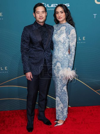Photo for Raymond Lee and Stacy Kusumolkul arrive at the 21st Annual Unforgettable Gala Asian American Awards held at The Beverly Hilton Hotel on December 16, 2023 in Beverly Hills, Los Angeles, California, United States. - Royalty Free Image