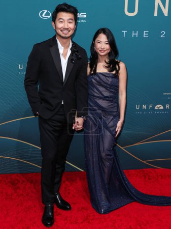 Photo for Canadian actor Simu Liu and girlfriend Allison Hsu arrive at the 21st Annual Unforgettable Gala Asian American Awards held at The Beverly Hilton Hotel on December 16, 2023 in Beverly Hills, Los Angeles, California, United States. - Royalty Free Image