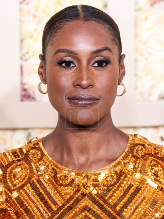 Photo for Issa Rae wearing a Pamella Roland dress, Rene Caovilla shoes, a Tyler Ellis clutch, and jewelry by Zydo, Ralph Masri, and Noudar arrives at the 81st Annual Golden Globe Awards held at The Beverly Hilton Hotel on January 7, 2024 in LA, USA. - Royalty Free Image