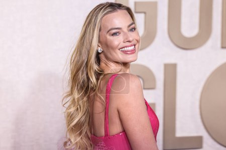 Photo for Margot Robbie wearing a Giorgio Armani Prive hot pink sequined gown and Manolo Blahnik shoes arrives at the 81st Annual Golden Globe Awards held at The Beverly Hilton Hotel on January 7, 2024 in Beverly Hills, Los Angeles, California, United States. - Royalty Free Image