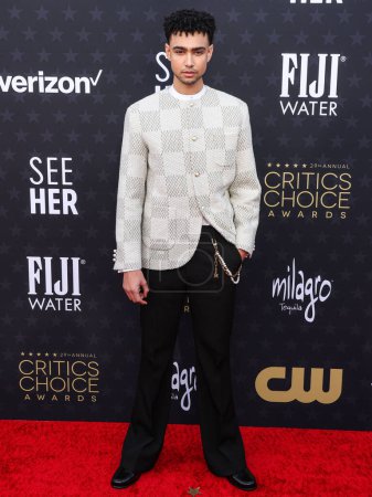 Photo for Archie Madekwe wearing Louis Vuitton and a Cartier watch arrives at the 29th Annual Critics' Choice Awards held at The Barker Hangar on January 14, 2024 in Santa Monica, Los Angeles, California, United States. - Royalty Free Image